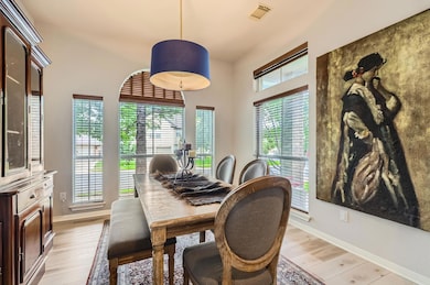 Dining area with light wood-style flooring and ba