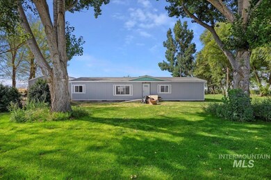 Back of property featuring a lawn and crawl space