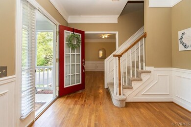 Entryway featuring ornamental molding, ceiling fan