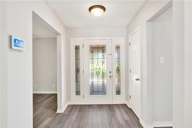 Foyer featuring baseboards and wood finished floor