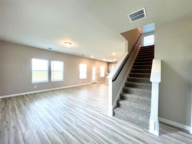Stairway featuring wood finished floors, baseboar