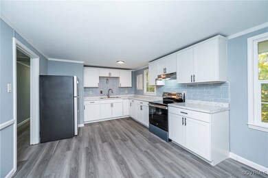Kitchen featuring white cabinets, a healthy amount