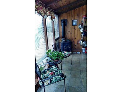 Exterior Front. Sun room with gas Stove