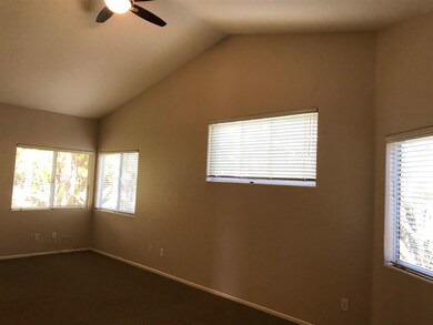 Master bedroom with vaulted ceilings.