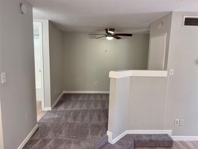 Unfurnished room featuring ceiling fan, a smoke d