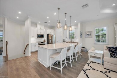 Kitchen with visible vents, a kitchen bar, light w