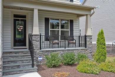 Exterior front porch featuring stone supports for 