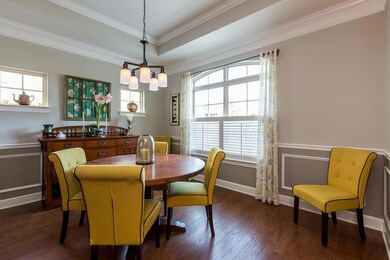 There is a formal dining room in the front of the home with panel detailing on the wall. It conveniently opens into the kitchen.