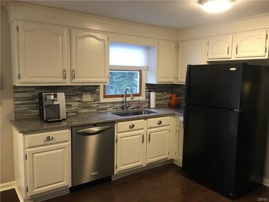 Beautiful dark laminate flooring throughout the downstairs helps to show off this beautifully redone kitchen.