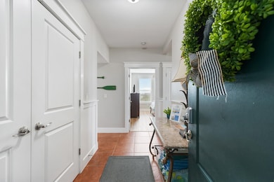 Welcome home to a charming entryway with coastal touches, tile flooring, and a spacious layout that provides a warm first impression.