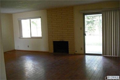 Good size living room with fireplace and sliding glass door to back  yard.