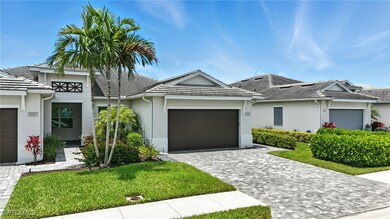 View of front facade featuring a garage, stucco si