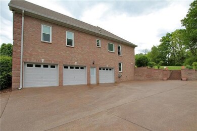 A three car garage with plenty of parking space in the driveway is one of the most useful features of this home.