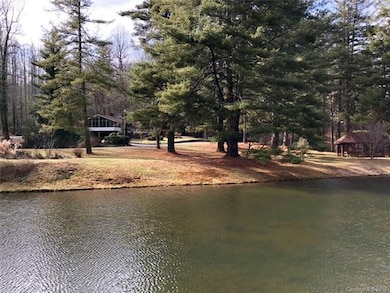 The view of the home and the community picnic shelter across the community lake.