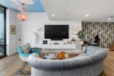 Living room with recessed lighting, baseboards, v