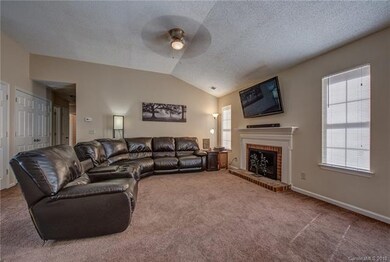 Spacious living room with mantle and wood burning 