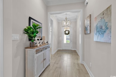 Entrance foyer with a chandelier,  baseboards, and