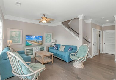 Living room with crown molding, hardwood / wood-st