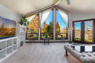Living area featuring vaulted ceiling and light carpet