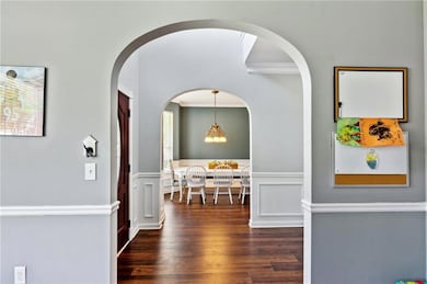 Grand entrance features hardwood floors, arched en