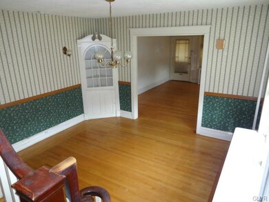 Dining Room has Wall Sconces and Built-In Hutch