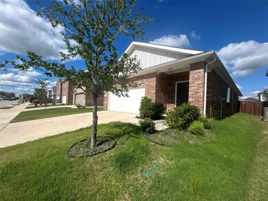 View of front of home featuring a front lawn and a garage