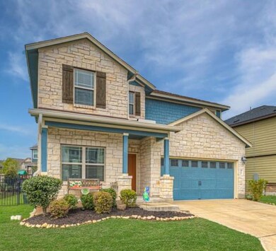 Traditional-style home featuring driveway, stone 