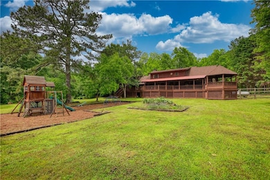 View of yard featuring a playground and view of scattered trees