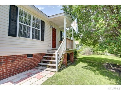Paver walkway and welcoming front porch.  Vinyl si