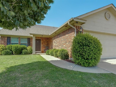 View of front of home featuring a garage, brick siding, a front lawn, and a shingled roof