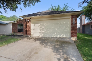 View of front of house with brick siding, a garag