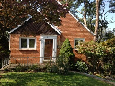 A closer look at the front entrance. Mature landsc