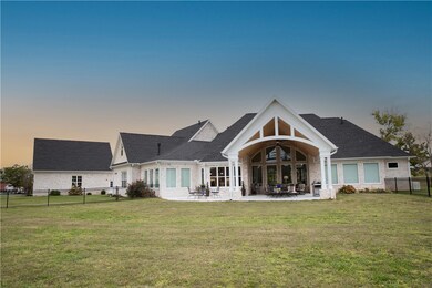 This is a view of the back of the home with a really sweet covered patio and wrought iron fenced yard area. Plenty of room for a pool!!!