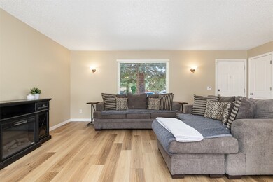Living area with light wood-style floors and a tex