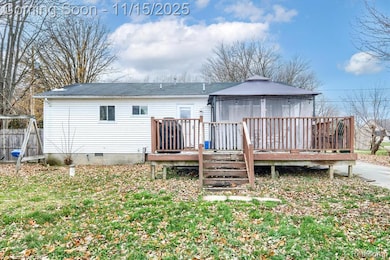 Back of house with a gazebo, a wooden deck, and crawl space