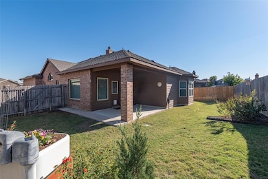 Relax under the covered patio.  Back yard is lovely, but low maintenance.