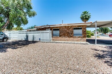Exterior Front of home with 2-car carport, desert