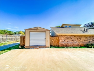 Garage with fence and a shed