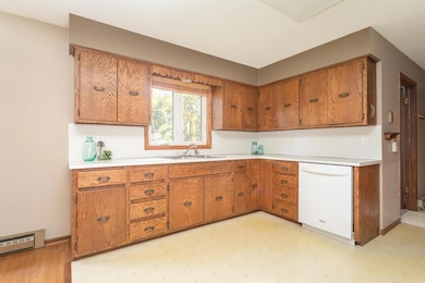 Kitchen has ample cabinets and counter space and a window which looks out over backyard.