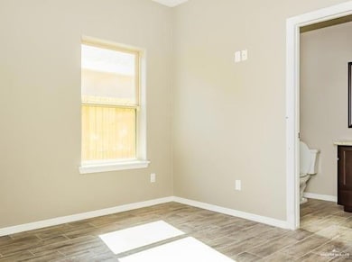 Unfurnished room featuring baseboards and wood finished floors