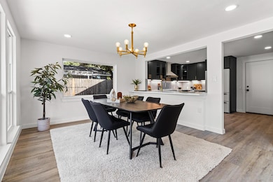 Dining room with recessed lighting, light wood-style flooring, and a chandelier