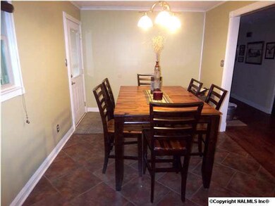 Dining area open to Kitchen with tile floor and crown mold.