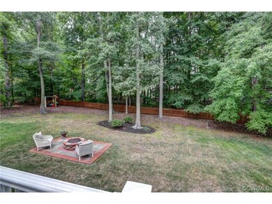 Huge fenced in rear yard with fire pit and patio