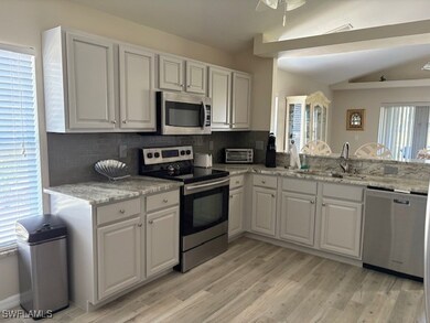 Kitchen featuring tasteful backsplash, a sink, whi