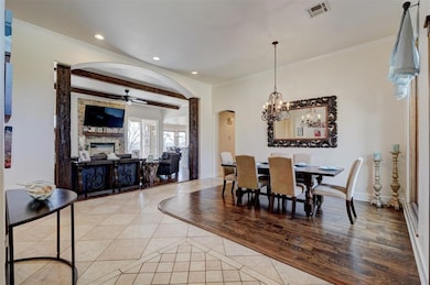 Dining area with beamed ceiling, ornamental moldin