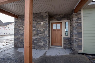 Welcoming front porch with rock accents.
