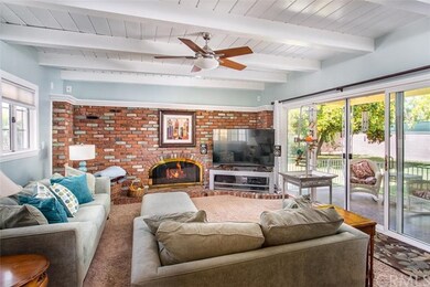 Den with fireplace & sliding doors to backyard 