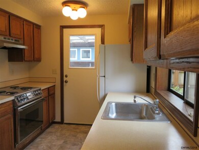 Galley style kitchen, side passage door & main lev