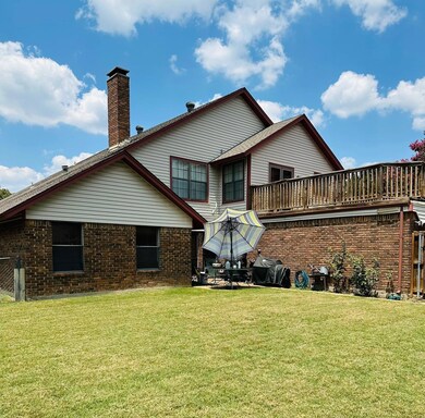 Back of property featuring a yard