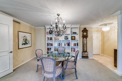 Dining room with carpet, an inviting chandelier, visible vents, ornamental molding, and baseboards